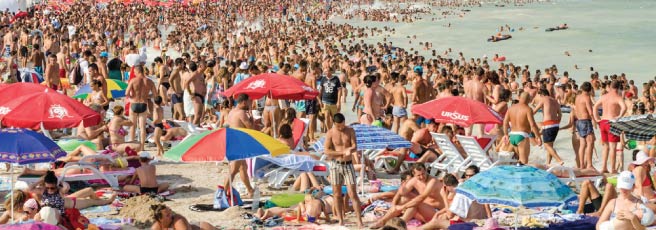 People sunbathing on a crowded beach